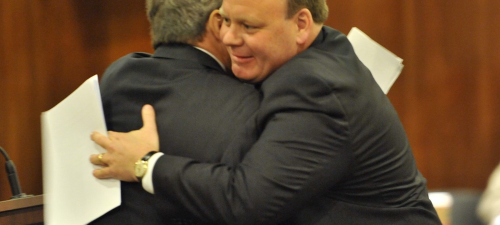 Cook County Commissioner John Daley, left, hugs Patrick Daley Thompson after he is sworn in as  a new commissioner of the Metropolitan Water Reclamation District Board.