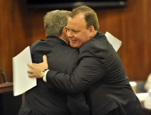 Cook County Commissioner John Daley, left, hugs Patrick Daley Thompson after he is sworn in as  a new commissioner of the Metropolitan Water Reclamation District Board.